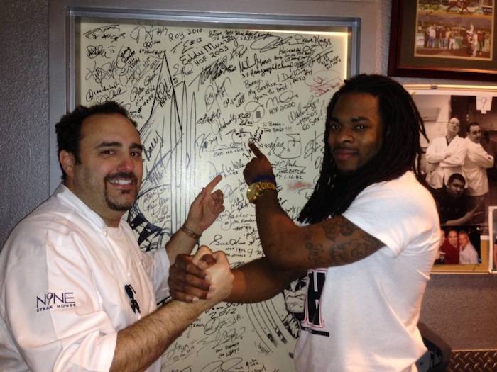 Chef Barry Dakake and Richard Sherman with the shakedown door.