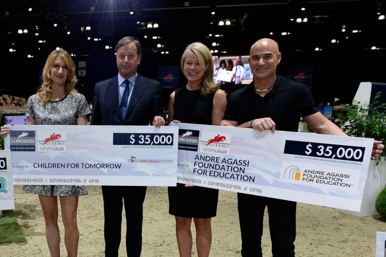 Andre Agassi, Jennifer Judkins, Longines Vice President Charles Villoz and Steffi Graf hold charitable donation checks raised during the Charity Pro-AM classic