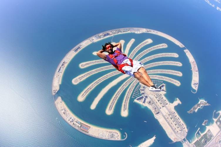 Omar Alhegelan floats above Palm Island during one of his world famous skydive performances. 